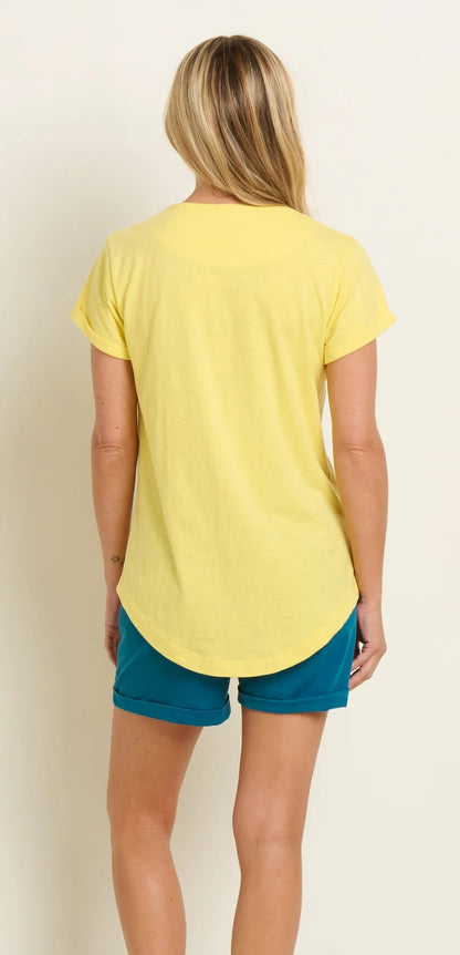 Women's yellow short sleeve Shore tee from Brakeburn featuring a coastal or seaside print with palm trees on the front.