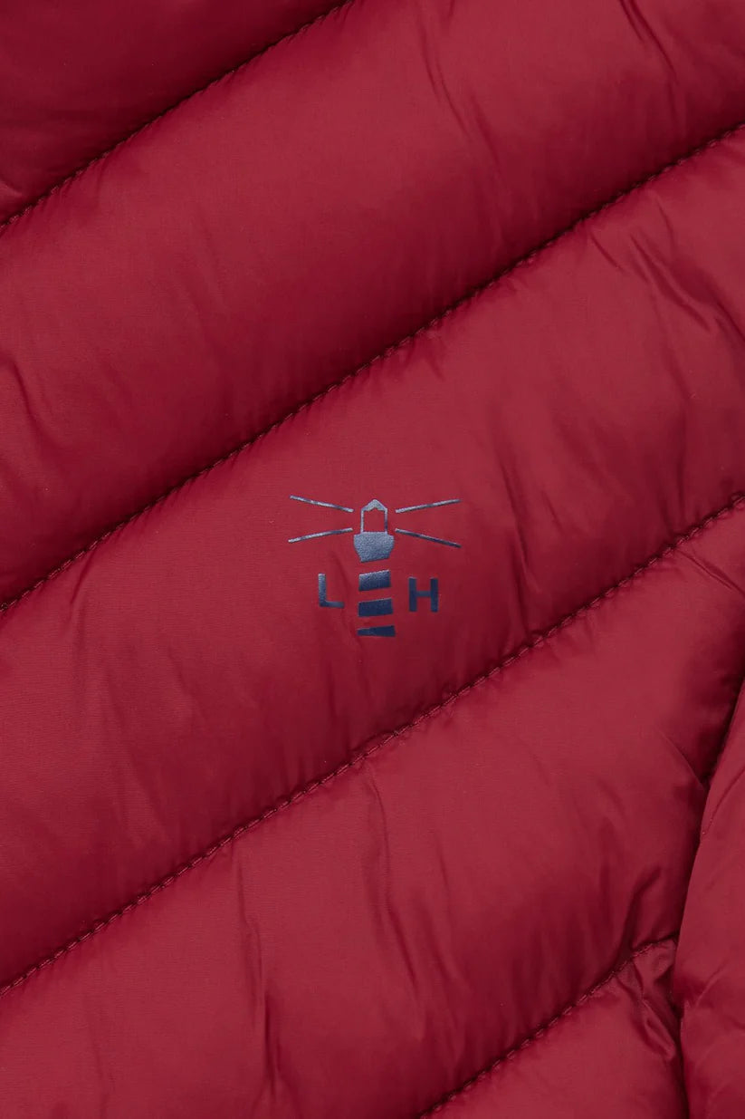 close up of lighthouse logo in navy on maroon gilet  