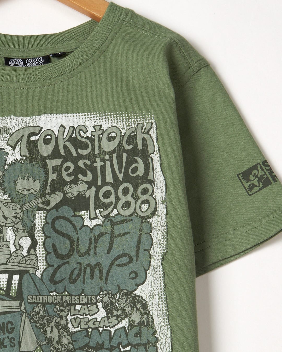 Saltrock kid's short sleeve Festival Merch T-shirt in Green with large print on the front and sleeve logo print.