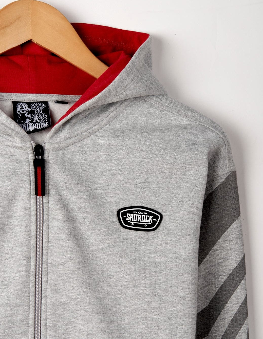 Kid's Saltrock Grip It zip through hoodie in light grey with check pattern sleeves, red lined hood and skate style logo.